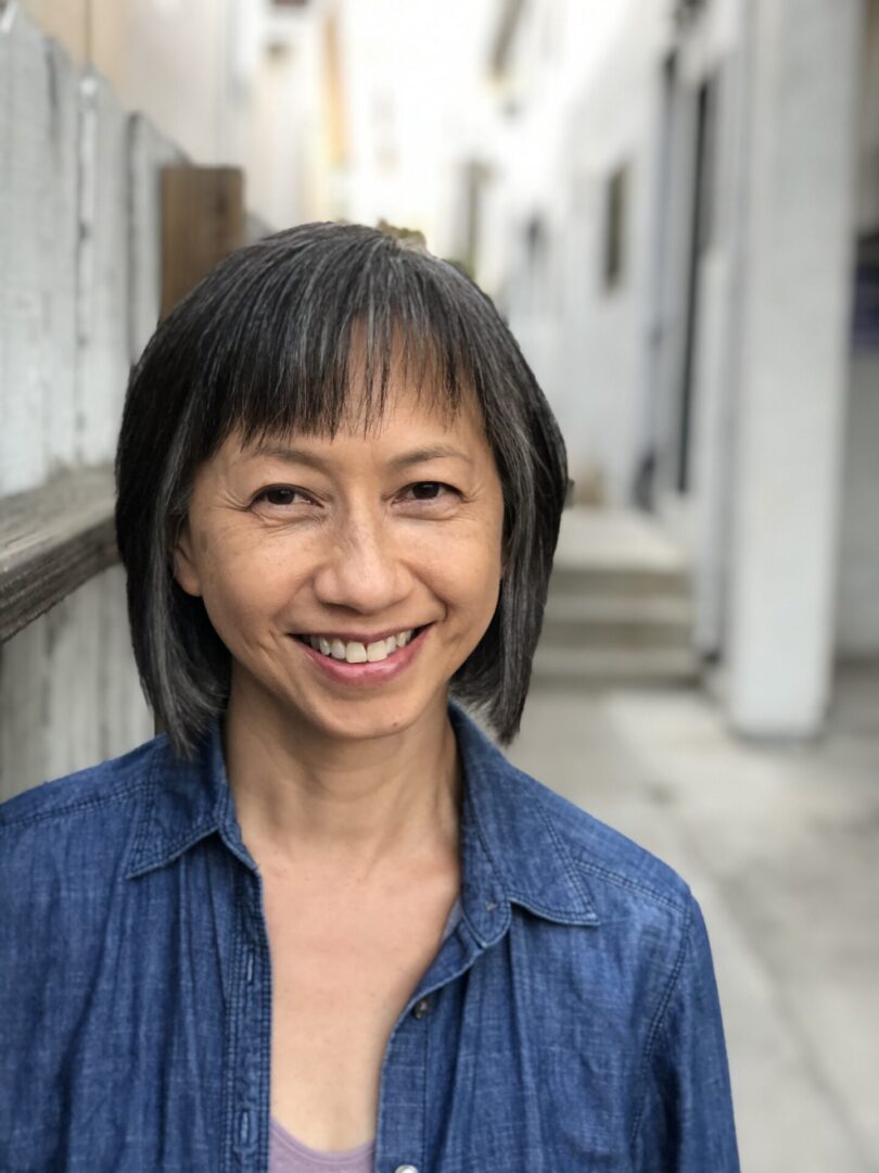 A woman with short hair and a blue shirt.